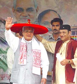 Prime Minister Atal Bihari Vajpayee wears a traditional Assamese japee presented to him by the BJP candidate for the Guwahati Lok Sabha seat, Bhupen Hazarika