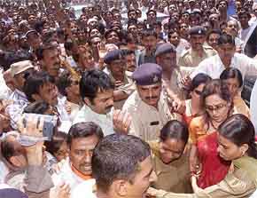 Veteran actress and Rajya Sabha MP Hema Malini being escorted by the police after she arrived for an election rally at Kheda near Ahmedabad