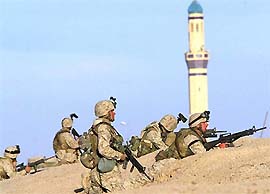 US Marines take cover during a gunbattle with Iraqi insurgents on the outskirts of Fallujah