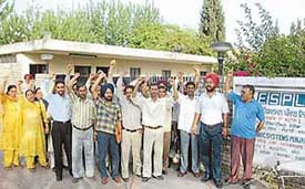 ESPL employees protest outside the company gate after being thrown out of their jobs in Mohali on Thursday.