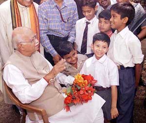 Deputy Prime Minister L.K. Advani interacts with schoolchildren at a village on the Patna-Ranchi national highway during the Bharat Uday Yatra