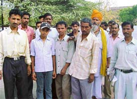 Labourers stand outside the SSPs office to complain against a factory owner near Doraha