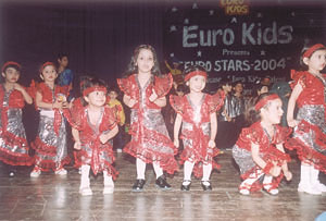 Children of Eurokids presenting a colourful cultural show at Siri Fort Auditorium.