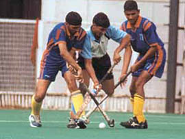 A keen tussle for the ball during the semi-final match between Ganga School and Union Academy in the D P Joshi Memorial Hockey Tournament at the Shivaji Stadium on Sunday.