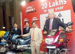 Hero Honda chairman Brijmohan Lall along with the company's MD Pawan Munjal and others