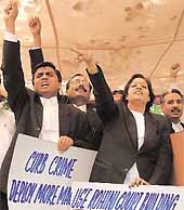 Members of the Delhi Bar Association protesting against the decision to shift civil cases for East Delhi to Karkardooma courts, in front of the Delhi High Court in the Capital