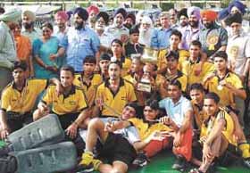 Players of Guru Harkishan Public School (India Gate) with the 2nd Sahibzada Ajit Singh Gold Cup trophy, who beat Lyallpur Khalsa School, Jalandar by 1-0 in the final at Shivaji Stadium in the Capital on Tuesday.