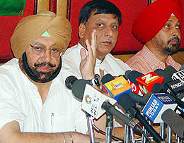 The Punjab Chief Minister, Capt Amarinder Singh, with Mr Prem Dutt Sharma and Mr Sarbjit Singh at a press conference in Chandigarh on Tuesday.
