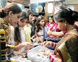 Students of fashion designing from Lahore having a close look at traditional Indian jewellery at the Madhya Pradesh emporium in New Delhi on Wednesday.