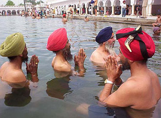 Devotees taking a holy dip on Baisakhi at the sarovar in Gurdwara Dukhniwaran Sahib in Patiala