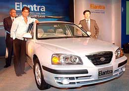 Bollywood actor Shah Rukh Khan, brand ambassador for Hyundai Santro, with Ji Kim, managing director, Hyundai Motors India Ltd, at the launch of Elantra in New Delhi