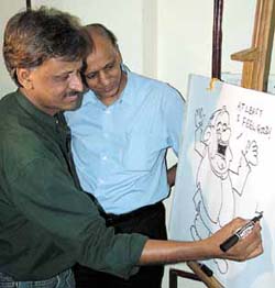 Cartoonist Sudhir Tailang depicting that laughter is the best medicine for heart in the Capital on Thursday. Dr K.K.Aggarwal, Executive Vice-Chairman-Heart Care Foundation of India is also seen in the picture. 