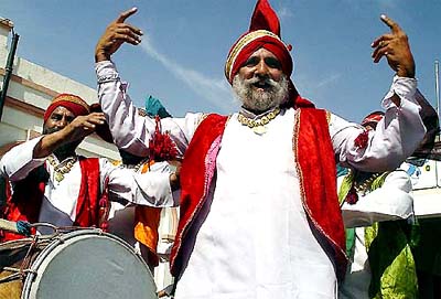 Members of a bhangra troupe perform at Ambala railway station