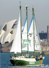 Greenpeace flagship Rainbow Warrior sails past the Sydney Opera House