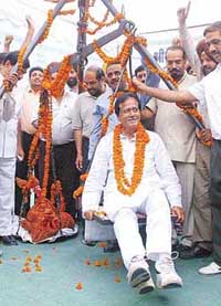 Mr Harmohan Dhawan, candidate of the INLD in the forthcoming elections, being weighed in coins