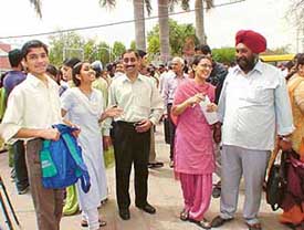 Students after taking the PMT test discuss the paper with their parents outside the examination centre at DAV Public School