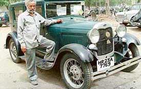 Mr Balbir Singh stands beside his Ford, which is the oldest car in Chandigarh