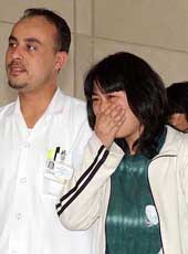 One of the released Japanese hostages, Nahoko Takato, cries after she arrives at an American hospital for a check-up in Dubai on Friday.
