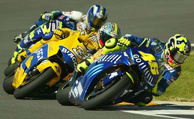 World champion Valentino Rossi of Italy takes a turn ahead of compatriot Max Biaggi and Sete Gibernau of Spain