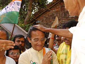 Mr Ajit Panja, Trinamool candidate and sitting MP from the North Kolkata Lok Sabha constituency, takes blessings from a priest during a door-to-door campaign