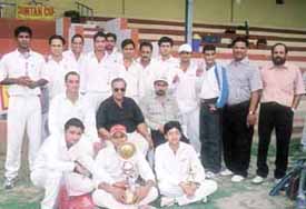 Former international umpire Desh Raj with the Pan Business List team who won the Suntan Cup Cricket Tournament