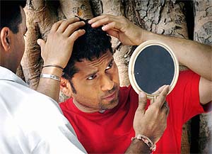 Sachin Tendulkar checks his hair in a mirror during a commercial shoot for Britannia biscuits at Mumbai