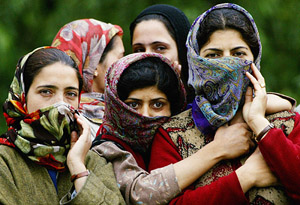Kashmiri women listen to a political speech