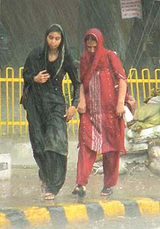 Two women enjoy a quite walk in the rain that lashed the Capital