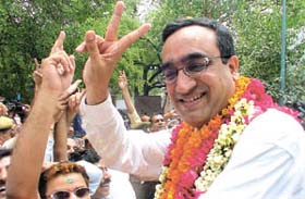 Congress candidate from New Delhi Ajay Maken flashes a victory sign after filing his nomination papers 