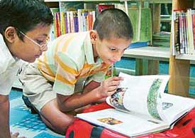 Fascinated by the gripping contents of a book, children enjoy the day on the occasion of World Book Day celebrations at the British Library in Sector 9 on Friday.