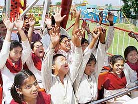 Visually impaired children enjoy during a ride at Thunder Zone Amusement Park near Sohana on Friday.