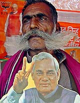 Man Singh Dange, a BJP supporter, holds a cutout of Prime Minister Atal Bihari Vajpayee