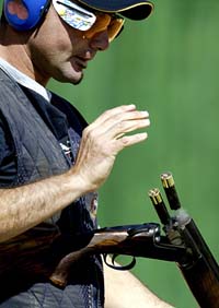 Australian double Olympic gold medallist in trap shooting, Michael Diamond, ejects cartridges from his rifle during men's trap qualification round at Athens' ISSF World Cup in Markopoulo Olympic Shooting centre