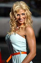 WWE female wrestling champion Torrie Wilson poses for photographers