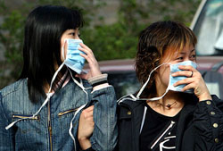 Two Chinese women wear masks before entering Ditan Hospital in Beijing on Friday where a suspected SARS patient is being treated. 