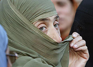A Kashmiri woman holds her scraft as she prays at the shrine of Sufi saint Khawaja Naqashband in Srinagar on his 340th death anniversary on Saturday.