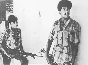 Two Tigers stand guard outside an LTTE office