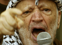 Palestinian President Yasser Arafat addresses supporters outside his Ramallah headquarters