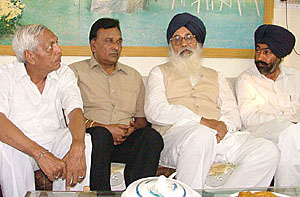 Mr Ved Romana, senior Congress leader, with SAD chief Parkash Singh Badal at Jaito in Faridkot district on Sunday. 