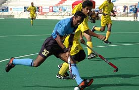 Indian forward Sandeep Michael breaks Malaysian defence during their match at the 5th Junior Mens Asia Field Hockey Tournament in Karachi