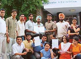 Students of the Department of Mathematics, Panjab University, alleging leak of their paper, sit on a dharna outside the VCs office