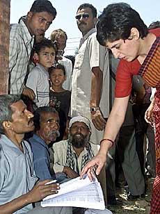 Priyanka Vadra, daughter of Sonia Gandhi, checks the voters list outside a polling station in Rai Bareli on Monday. 