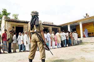 People wait for their turn to cast their vote amid tight security