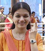 Small screen actress and BJP supporter Prachi Shah shows her marked finger after casting her vote