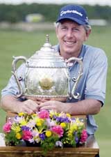 Hale Irwin poses with his trophy on the 18th green after winning the PGA Champions Tours Liberty Mutual Legends of Golf