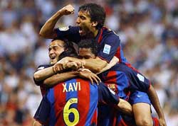 Barcelonas Xavi Hernandez is congratulated by team-mates Luis Enrique (L) Giovanni Van Bronckhorst (top) and Patrick Kluivert after scoring the second goal against Real Madrid