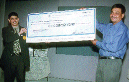 Mr Manoj Shirodkar, Country Director, Herbalife International, handing over a cheque of Rs 15 lakh to Mr Pradeep Singh, National Director, SOS Childrens Villages of India