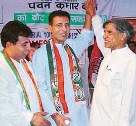 The President of the All-India Youth Congress Randeep Singh Surjewala flanked by Mr Pawan Kumar Bansal, Congress candidate, and Mr H.S. Lucky, president, Youth Congress, Chandigarh, at a rally in Chandigarh on Thursday.