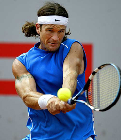 Spains Carlos Moya returns a shot to Germanys Daniel Elsner during their second round match at the Barcelona Open in Barcelona, Spain