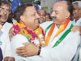 In a rare moment, a Congress supporter embraces Mr Hem Raj Kashyap, candidate of the BSP, during campaigning in Mani Majra, Chandigarh